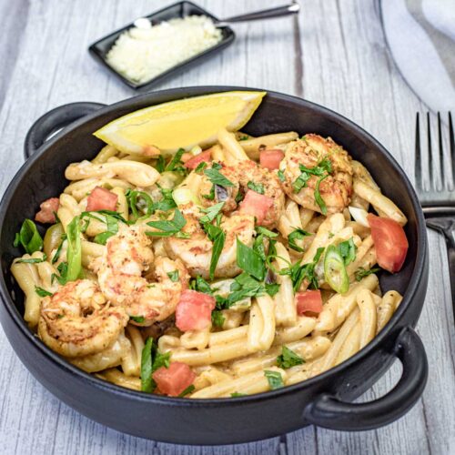 Cajun Pasta with Shrimp on a black skillet.