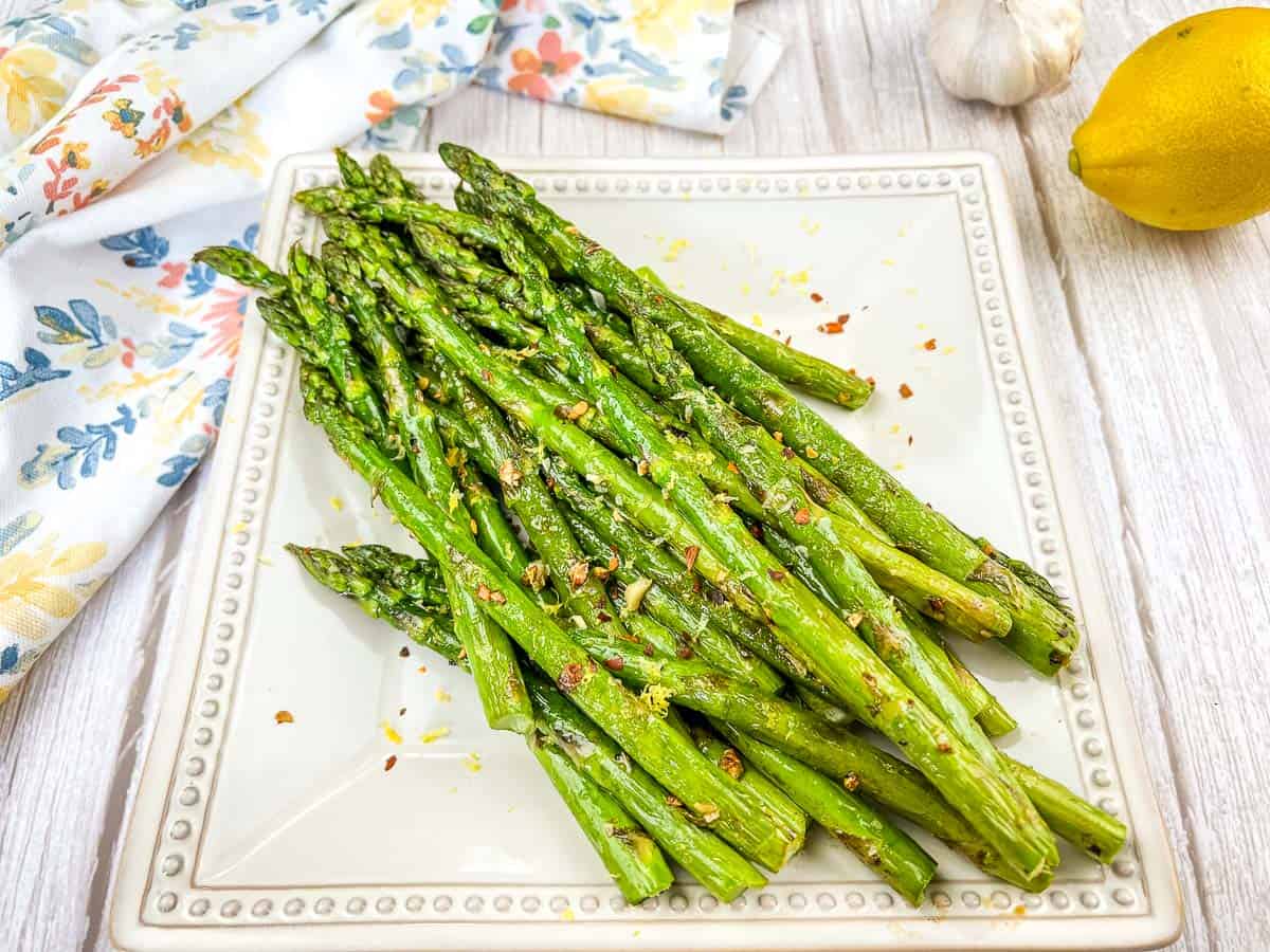 Grilled Asparagus on a white square plate.