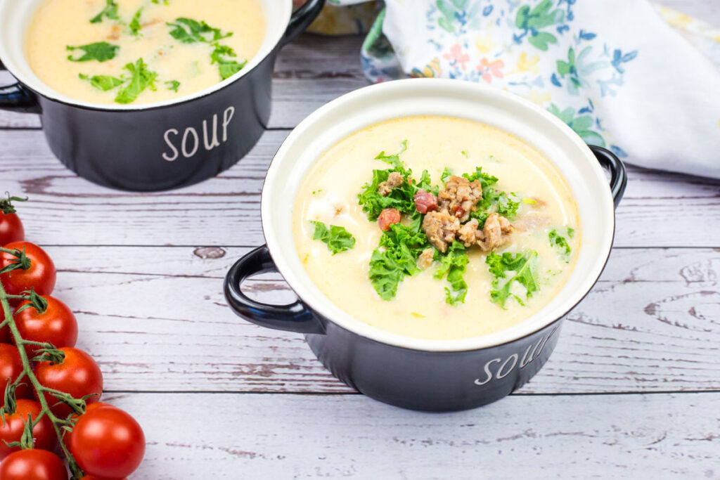Creamy Tuscan Soup With Sausage & Kale in a bowl.
