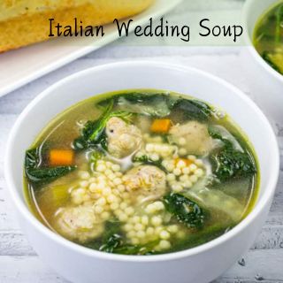 A white bowl of Italian Wedding Soup.
