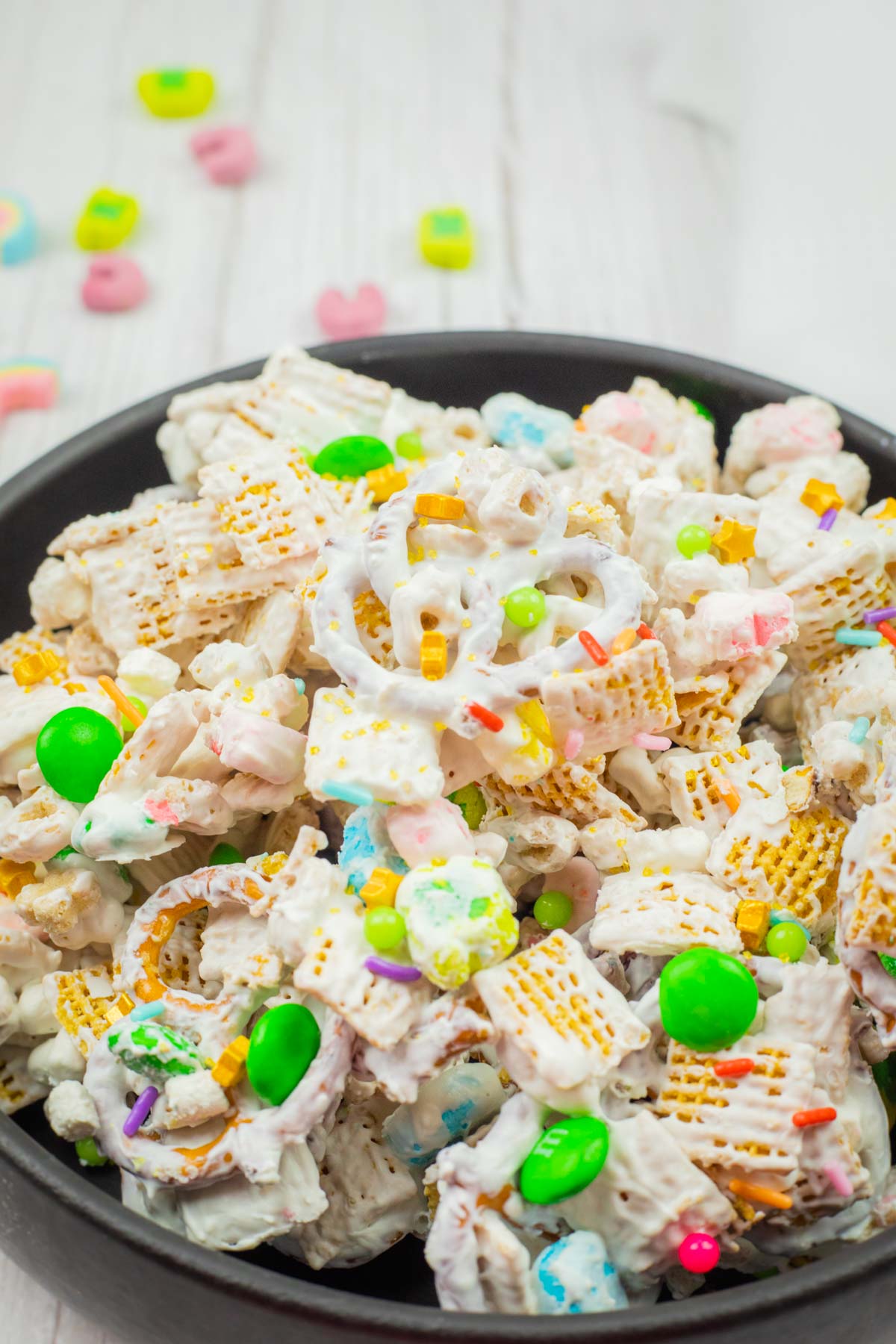 A bowl of Leprechaun Bait on a wooden table.