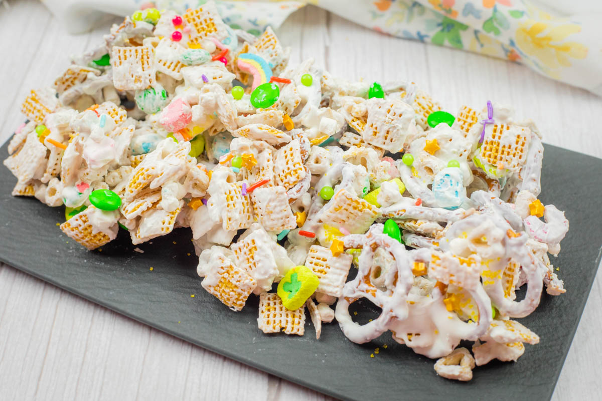 A slate tray of Leprechaun Bait beside a napkin on a wooden surface.