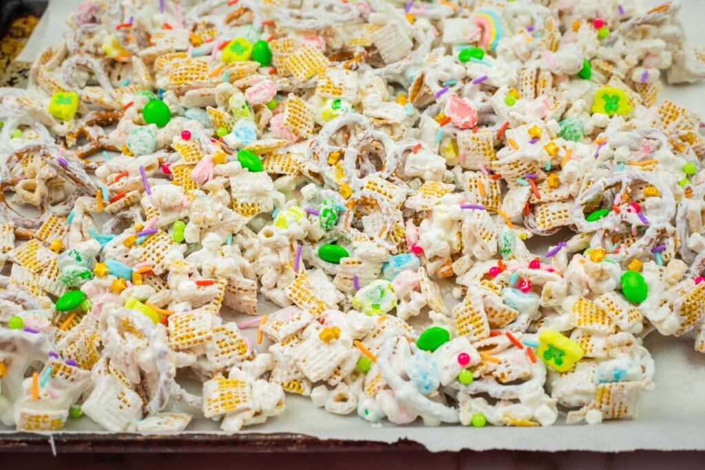 A tray of cereal snack mix with colorful candies and festive sprinkles.