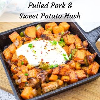 A serving of Sweet Potato Hash and Pulled Pork with heavy cream on a skillet.