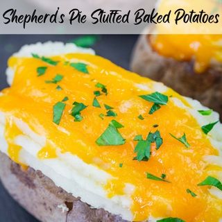 Baked potatoes topped with mashed potatoes, melted cheddar cheese, and chopped parsley, labeled as "Shepherd's Pie Stuffed Baked Potatoes.