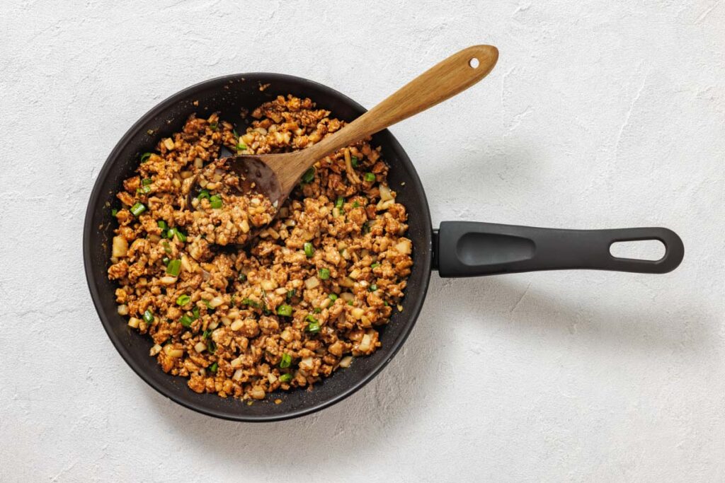 Cooking ground chicken.