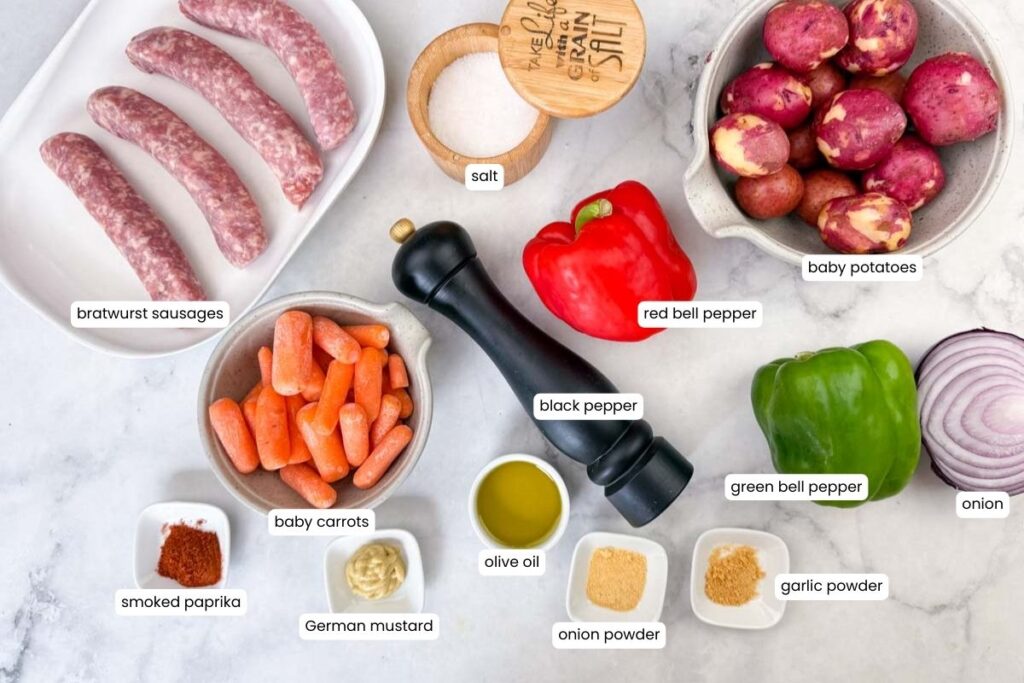 Ingredients for a bratwurst sausage dish arranged on a counter, including sausages, vegetables, spices, olive oil, and salt, each labeled with text.