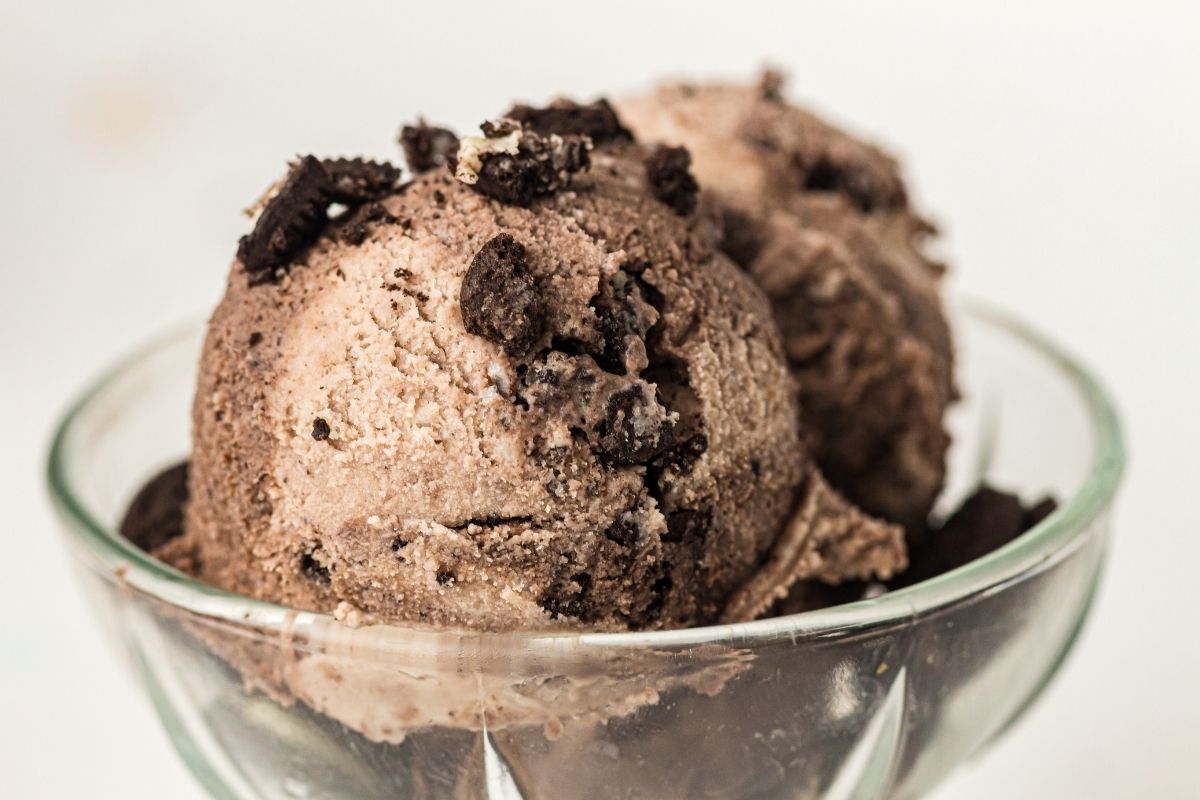 Two scoops of Cookies And Cream Ninja Creami Ice Cream in a clear glass bowl.
