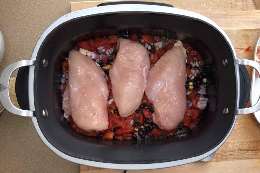 A crock pot with meat and vegetables.