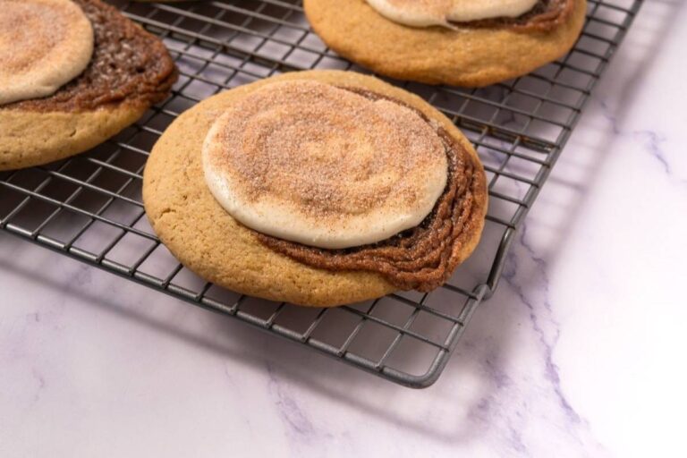 Close-up Crumbl Copycat Cinnamon Swirl Cookies on a wire rack.